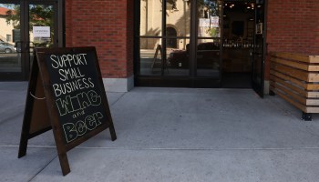 A sign reading Support Small Business is displayed outside of a restaurant on March 26 in Arizona.
