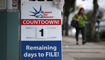 A sign advertising one day remaining before the tax filing deadline in front of Liberty Tax Service in San Francisco.