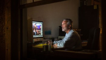 A man works from home on two computers