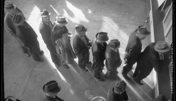 ![Some of the first recipients wait to receive benefits at the division office of the State Employment Service in San Francisco, California, 1938.