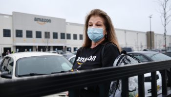 An Amazon employee at the company's Staten Island distribution facility. The giant retailer is phasing out its hazard pay.