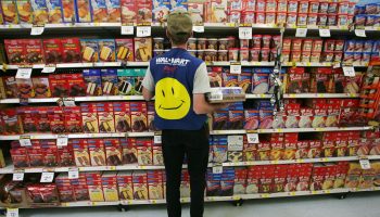 An employee restocks a shelf at an Ohio Walmart. Employees shop for customers for the chain's popular curbside pickup option.