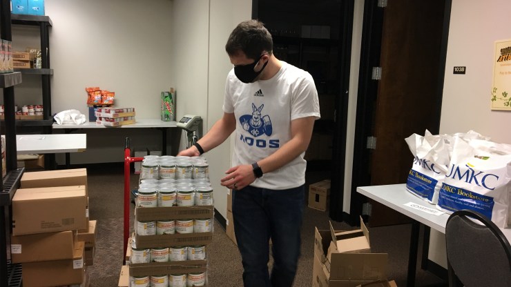 Anthony Maly, senior program manager in the University of Missouri-Kansas City Office of Student Involvement, unloads canned goods at the school’s food pantry.