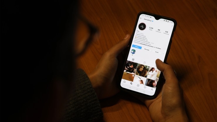 A woman looks at the Instagram page of a Saudi influencer.