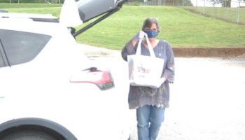 Jennifer Pearson, director of the Marshall County Library in Tennessee, with a bag of books for curbside pickup.