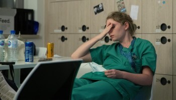 A tired nurse at a hospital. Disrupted living is affecting how well people sleep.