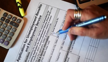 A person fills out an unemployment benefits application. The addition of $600 a week has enabled many Americans to keep spending and support businesses.