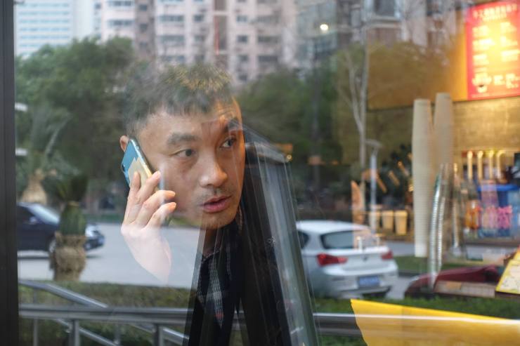 Businessman Wang Xiaojian likes to send clients an overdue invoice and follow up with a phone call. He said in China it is best to be gentle when chasing debt. (Jennifer Pak/Marketplace.)