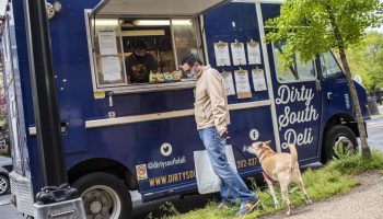 A customer and his dog at a food truck. Office closures and canceled summer gatherings have forced many operators to rethink their business models.