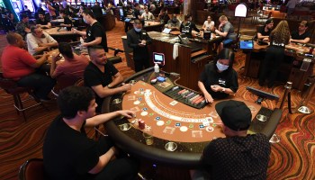 Guests play blackjack at tables with only three players allowed at a time at the Red Rock Resort after the property opened for the first time since being closed on March 17 because of the coronavirus (COVID-19) pandemic on June 4, 2020 in Las Vegas, Nevada.