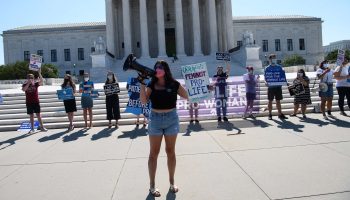 Antiabortion activists demonstrate in front of the Supreme Court in Washington, D.C., on Monday. The court rejected a Louisiana abortion curb in a key victory for abortion rights activists.