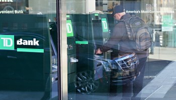 A man withdraws cash at a New York ATM in March.