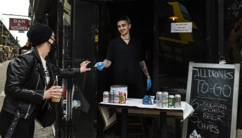 A bartender sells a frozen margarita to go in New York City.