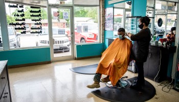 A man gets his hair cut at a barbershop in Austin, Texas, in May.