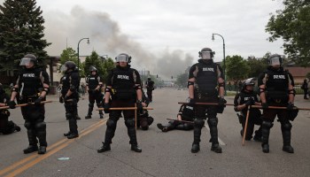 Police block a road in Minneapolis as protests against police brutality continue.