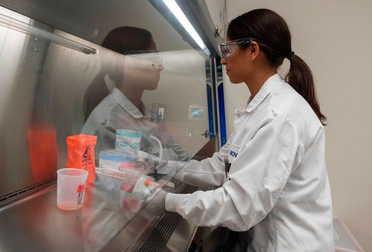 A doctor samples proteins at Novavax labs in Gaithersburg, Maryland, in March. Novavax is one of the labs developing a vaccine for the coronavirus.