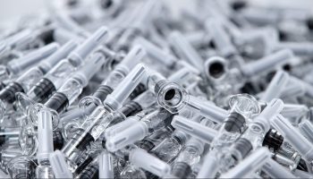A photo shows vaccines in prefilled, single-use syringes before the inspection and packaging phase at the French pharmaceutical company Sanofi's world distribution center in Val de Reuil on July 10, 2020.