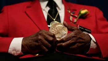Tuskegee Airman Major Anderson shows off a Congressional Gold Medal given to all Tuskegee Airmen during a ceremony commemorating Veterans Day and honoring the group of World War II airmen on Nov. 11, 2013, in Washington, D.C.