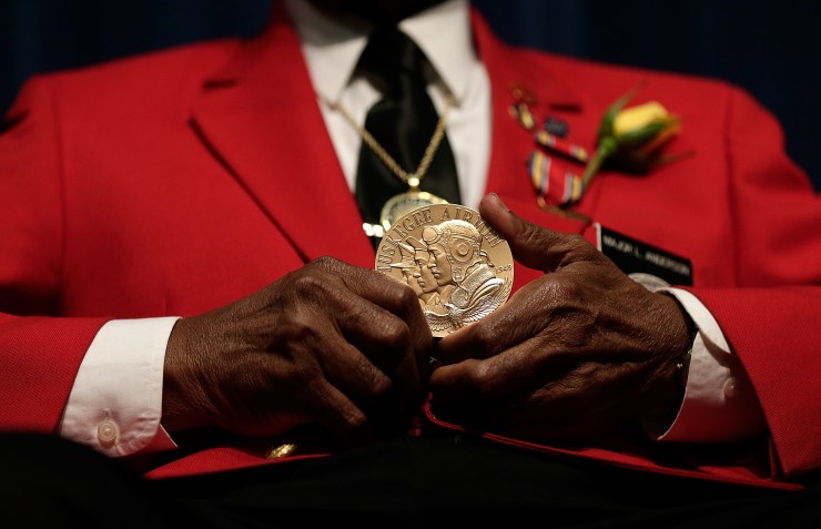 Tuskegee Airman Major Anderson shows off a Congressional Gold Medal given to all Tuskegee Airmen during a ceremony commemorating Veterans Day and honoring the group of World War II airmen on Nov. 11, 2013, in Washington, D.C.
