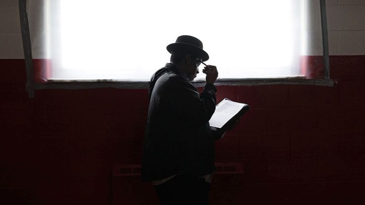 A man fills out an application at a job fair at the Matrix Center April 23, 2014 in Detroit, Michigan.