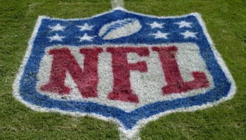 The NFL symbol on stadium turf.