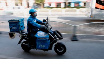 A food delivery worker drives along the streets of Shanghai. Chinese companies seem to have invested more in the logistics of app-based delivery than U.S. companies so far.