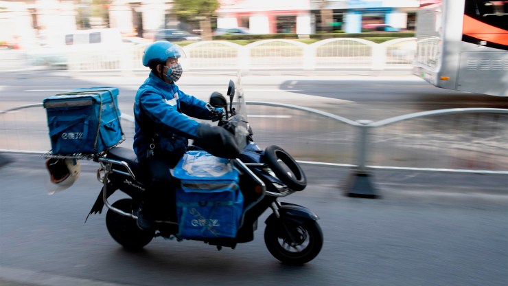 A food delivery worker drives along the streets of Shanghai. Chinese companies seem to have invested more in the logistics of app-based delivery than U.S. companies so far.