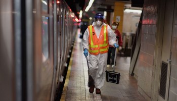 A public transit worker cleans subway trains in New York City. State and local government budgets have been battered, and jobs are at risk.