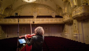 A violinist plays to an empty concert hall during a video-recorded concert in Slovakia in May.