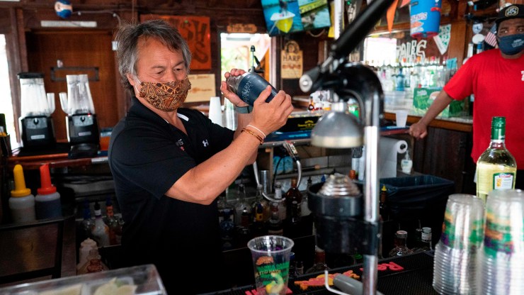 A bartender mixes a drink at a Maryland restaurant.