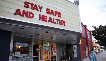 A shuttered movie theatre with the marquee reading "Stay safe and healthy" in Los Angeles.