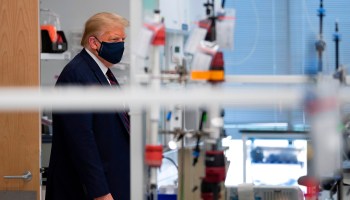 President Donald Trump tours a North Carolina lab making components for a potential vaccine. The U.S. has struck deals with drug companies for access to coronavirus vaccines in development.