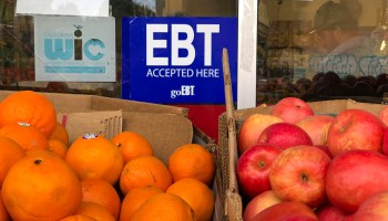 Oranges and apples sit under a sign signifying the Oakland store accepts electronic benefit transfer cards used by California welfare departments.
