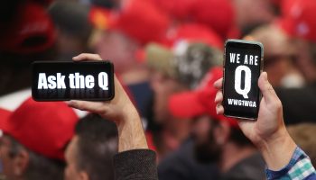 Supporters of President Donald Trump hold up their phones with messages referring to the QAnon conspiracy theory at a campaign rally at Las Vegas Convention Center on February 21, 2020 in Las Vegas, Nevada.