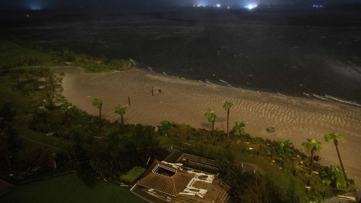 A picture taken on August 27, 2020 shows a destroyed building on a beach as the eye wall of hurricane Laura passes over in Lake Charles, Louisiana.