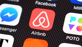 The Airbnb app logo is displayed on an iPhone on August 3, 2016 in London, England.