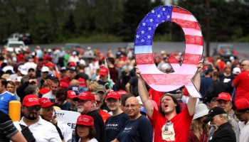 David Reinert holds up a large "Q" sign while waiting in line to see President Donald J. Trump at his rally on August 2, 2018 at the Mohegan Sun Arena at Casey Plaza in Wilkes Barre, Pennsylvania.