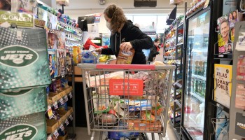A woman checks out her purchases at a grocery store in New Jersey. CPI tracks the monthly change in the cost of consumer goods and services.