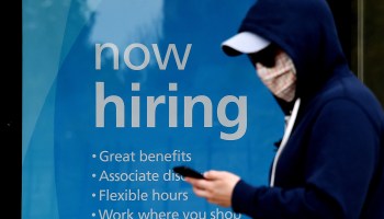 A "now hiring" sign at a store in Arlington, Virginia. Employers may take the pandemic lockdown into consideration when seeing gaps in applicants' resumes.