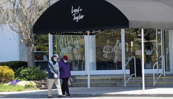 Pedestrians walk past a shuttered Lord & Taylor department store in Garden City, New York. on May 12.