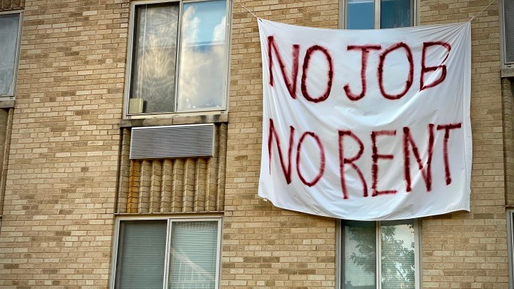 A banner at a rent-controlled building in Washington, D.C., illustrates the plight of many tenants and landlords during the current economic disruption.