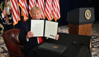 President Donald Trump signs an executive order and three memorandums extending coronavirus economic relief on Aug. 8.