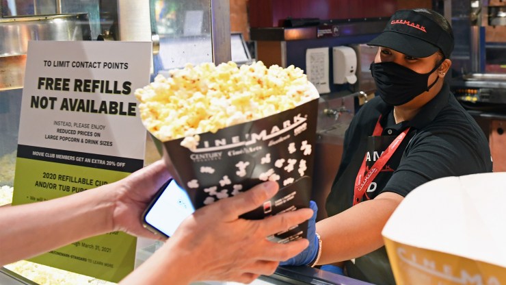 A customer purchases popcorn at a reopened movie theater in Las Vegas last week.