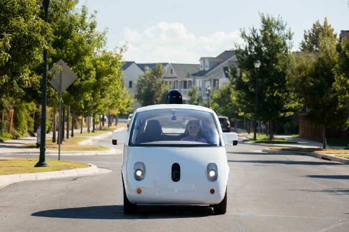 Steve Mahan, who is legally blind, riding in Google's Firefly self-driving car down a street in Austin, Texas.
