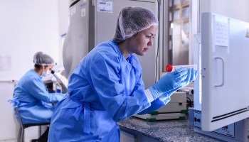 Larissa Vuitika, biologist, takes coronavirus DNA sample from the freezer on March 24, 2020 in Belo Horizonte, Brazil.
