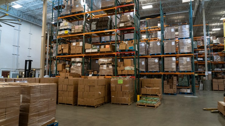 Goods stacked on warehouse shelves. The pandemic is accelerating the shift to shopping at home, making the role of the warehouse more central.