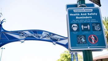 In this handout photo provided by Disneyland Resort, a variety of shopping and dining experiences will begin reopening at the Downtown Disney District on July 9, 2020 in Anaheim, California. Pictured is a sign encouraging proper safety measures for guests including wearing a face mask and social distancing.