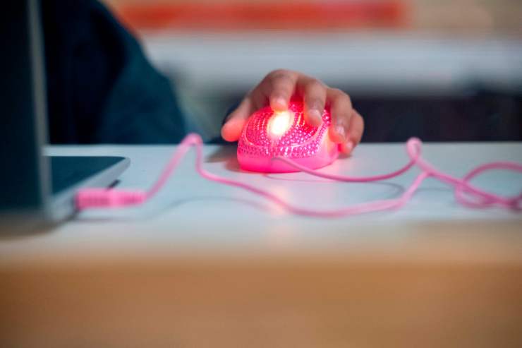 A student's glowing, pink computer mouse is seen as they follow along with their teacher's online lesson on September 10, 2020 in Culver City, California.