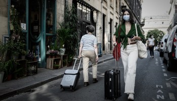A woman wearing a protective face mask walks on a street where wearing a mask is mandatory in Bordeaux, southwestern France, on September 16, 2020.