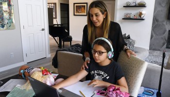 Amy Conrad helps her daughter, Luca Conrad, 10, a Goolsby Elementary School fourth grader, take an online class at their home during the first week of distance learning for the Clark County School District in Las Vegas in August.